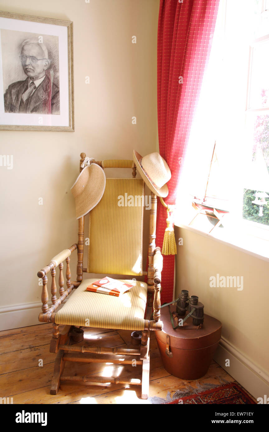 An Edwardian rocking chair in the corner of a traditional bedroom Stock Photo