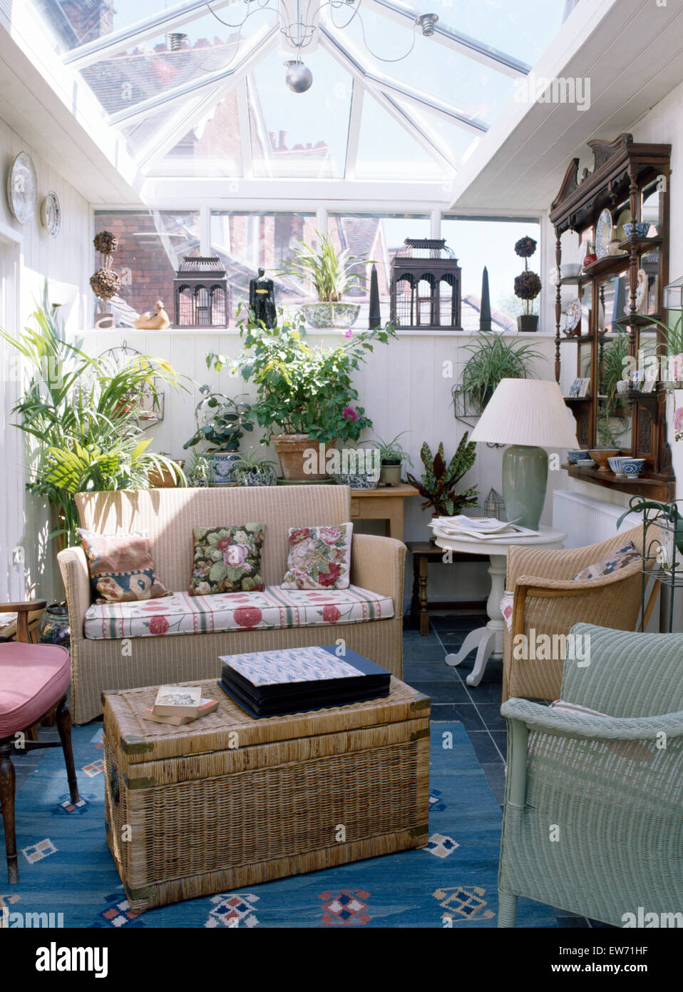 rattan living room furniture indoor on Wicker Chest And Painted Wicker Furniture In Living Room Extension With Glass Roof And Lush Green Houseplants Stock Photo Alamy