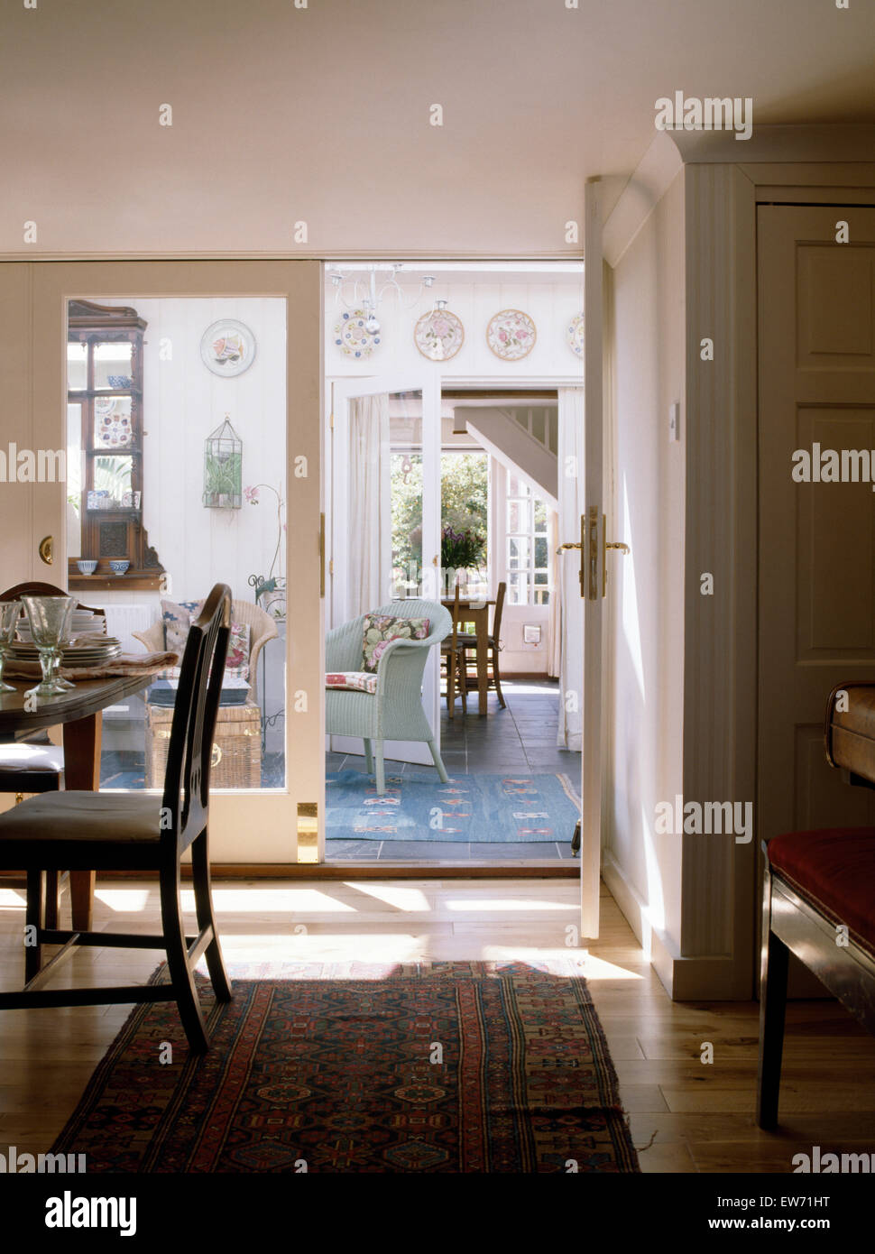 Dried blue flowers and wheat, wicker chairs in dining room with big glass  table and decorations. Cozy, vintage, rustic atmosphere at home. Concept of  Stock Photo - Alamy