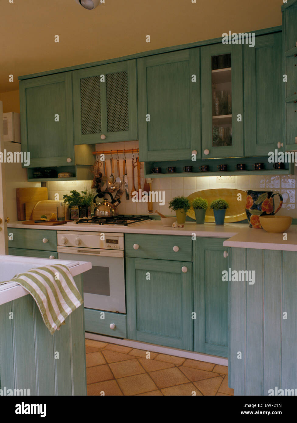 Pale blue-gray fitted cupboards in traditional kitchen Stock Photo