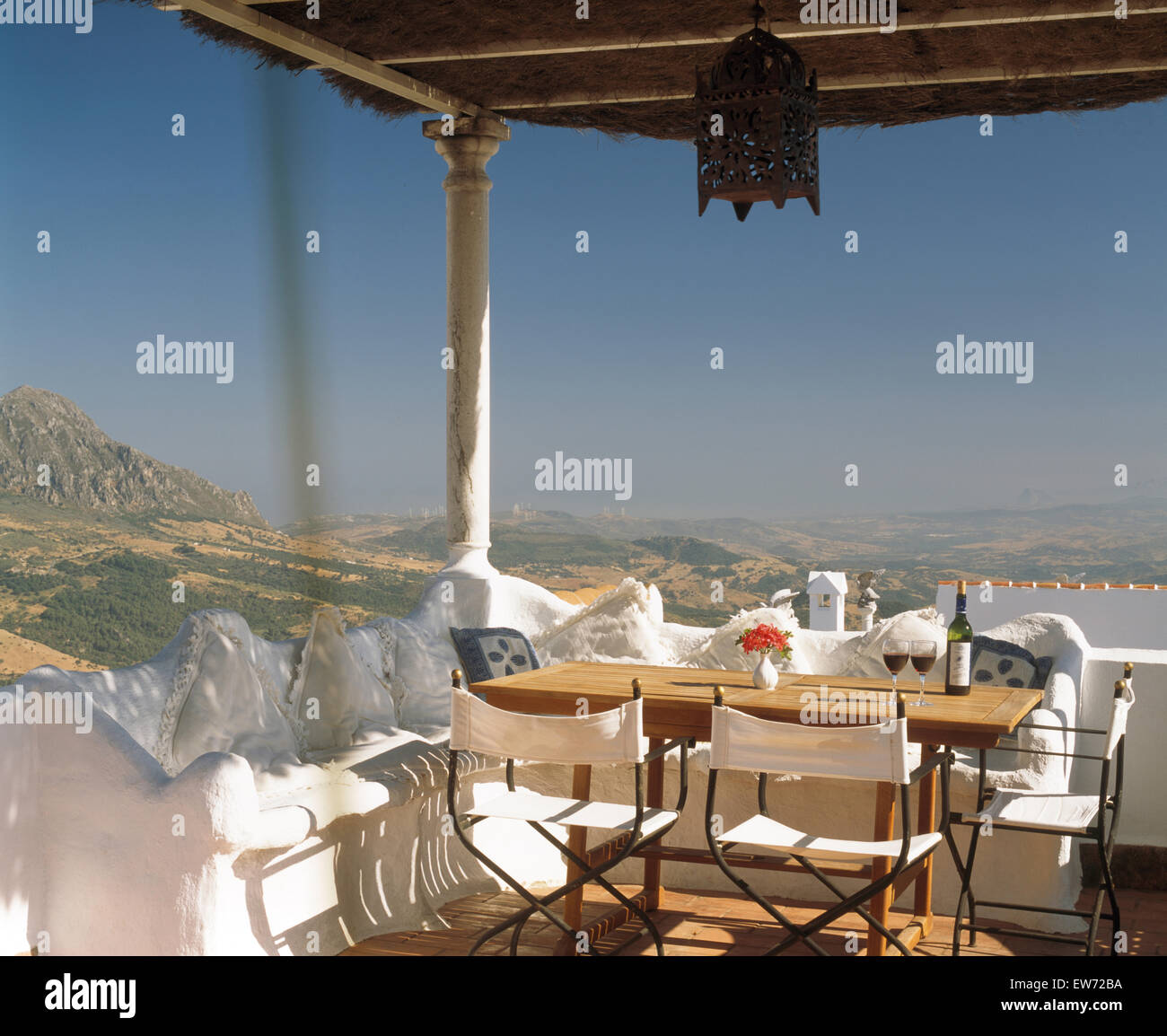 White canvas chairs at table set for lunch on terrace of  villa in southern Spain Stock Photo