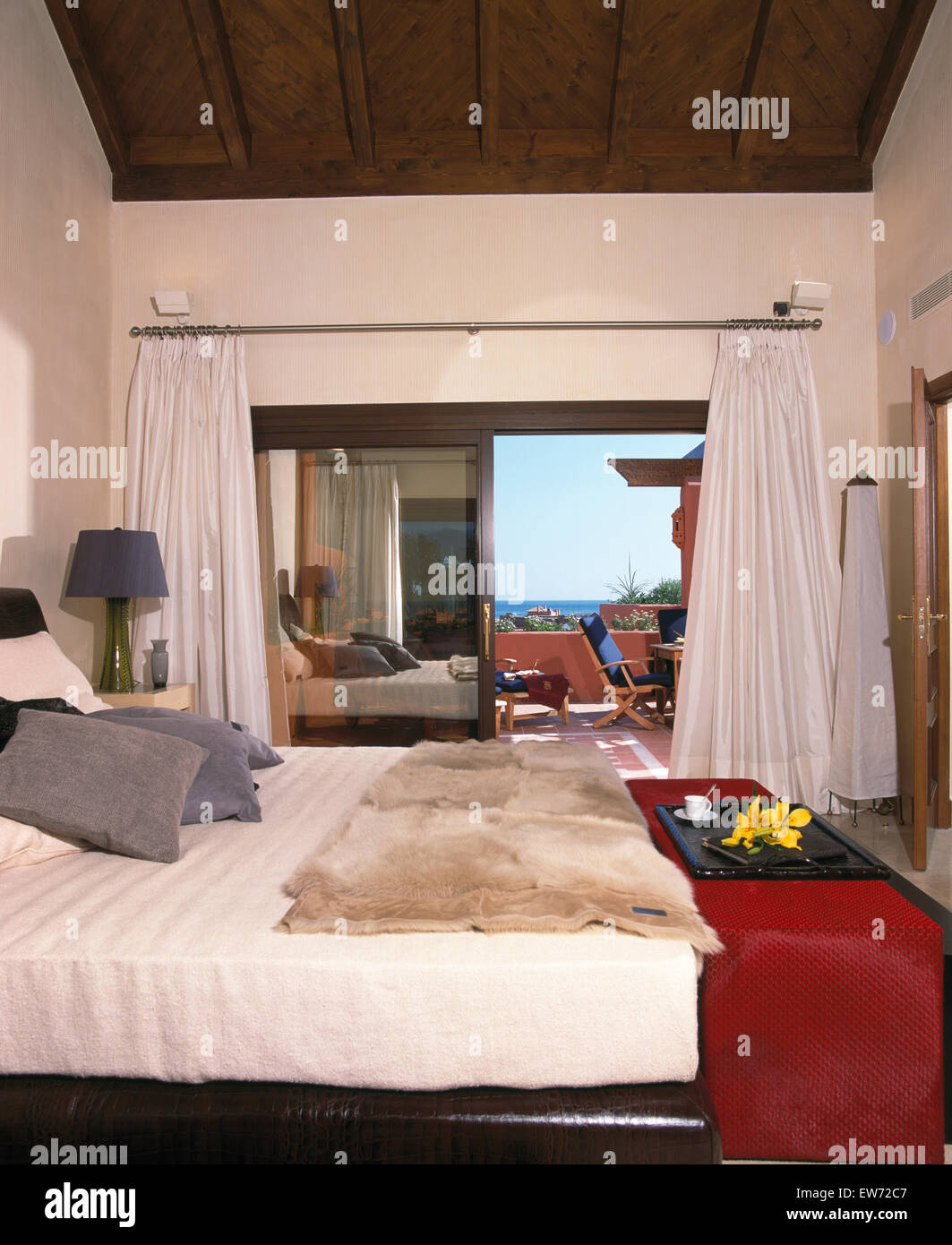 Faux Fur Throw On Bed In Spanish Bedroom With White Drapes