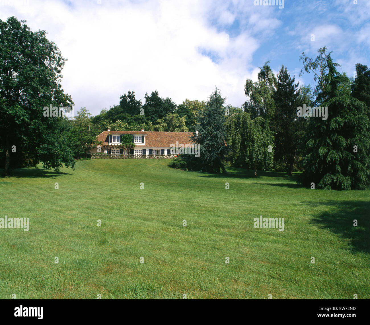 Large lawn and trees in garden of a French country house Stock Photo
