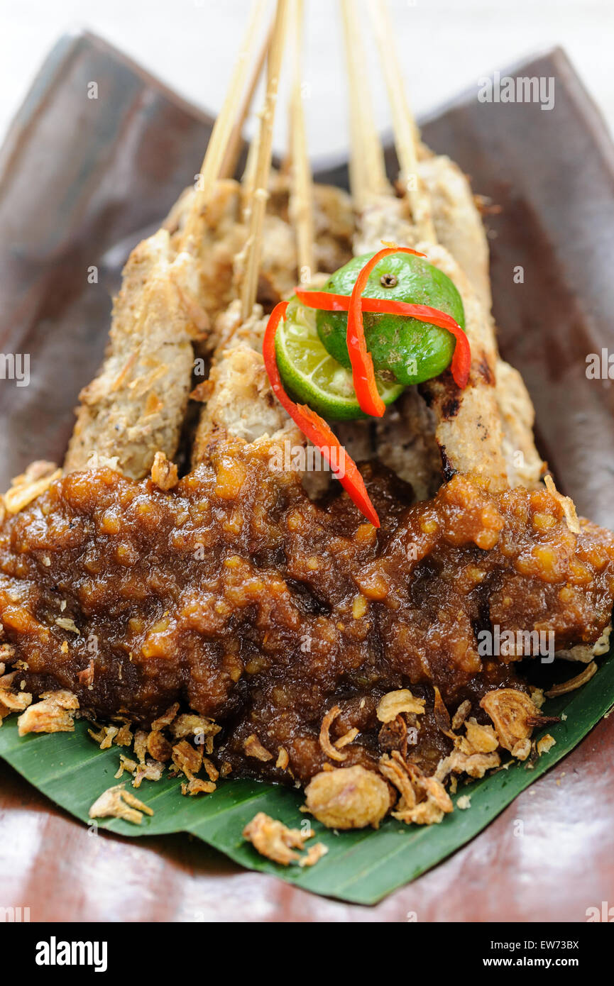 Indonesian chicken sate served with peanut sauce. Stock Photo