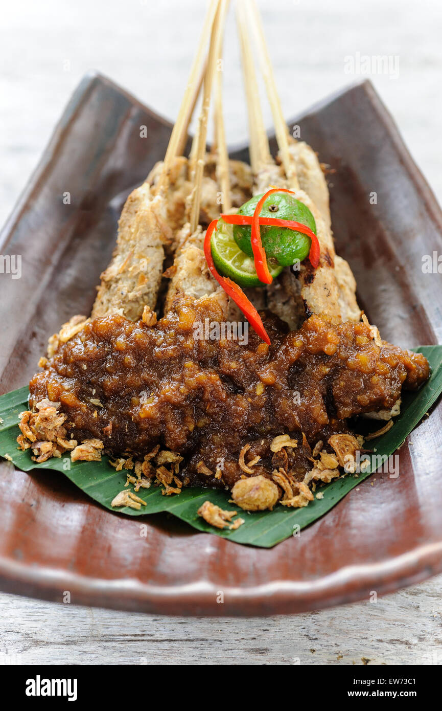 Indonesian chicken sate served with peanut sauce. Stock Photo