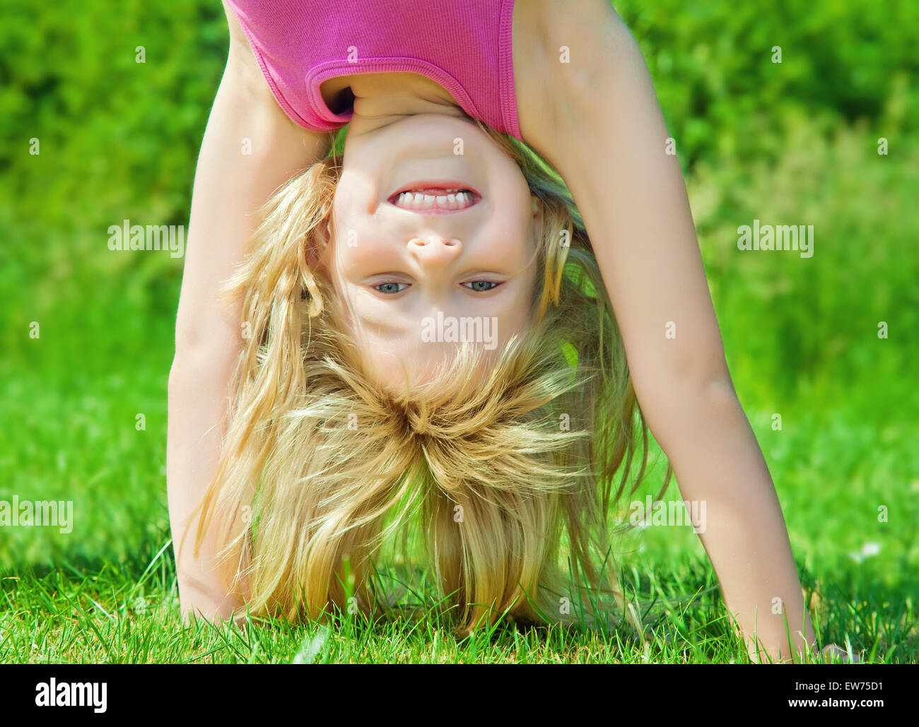 young girl doing a handstand Stock Photo