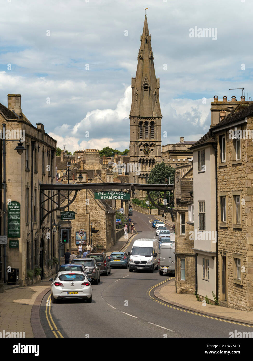 Stamford High Street St Martins with The George Hotel Arch and St Mary's Church, Stamford, Lincolnshire, England, UK. Stock Photo
