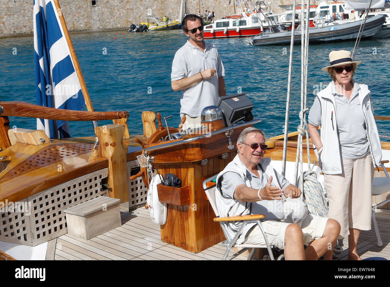 Spetses Island, GREECE. 19th June, 2015. King Constantine of Greece, Queen Anne-Marie of Greece and their son Prince Nikolaos on their traditional boat ''Afroessa at the port of Spetses island during the ''Spetses Classic Yacht Race Regatta' Credit:  Aristidis Vafeiadakis/ZUMA Wire/Alamy Live News Stock Photo