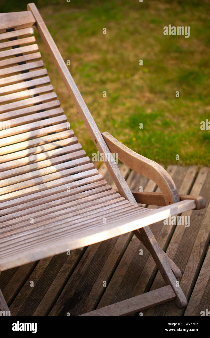 Wooden deck chair on a terrace in a garden Stock Photo - Alamy