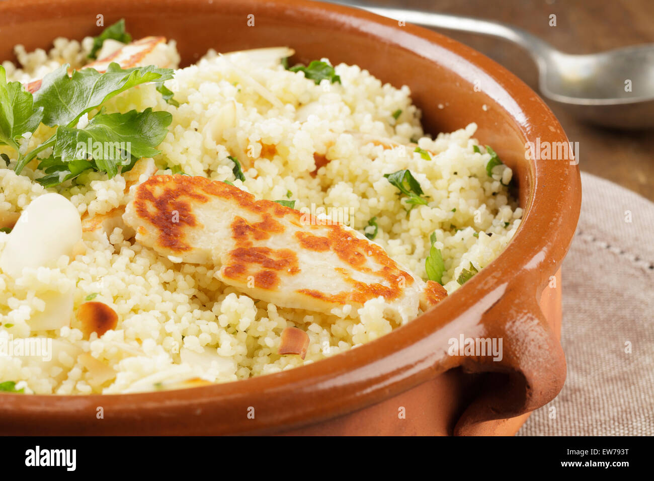 Lemon and parsley couscous with almonds and halloumi Stock Photo