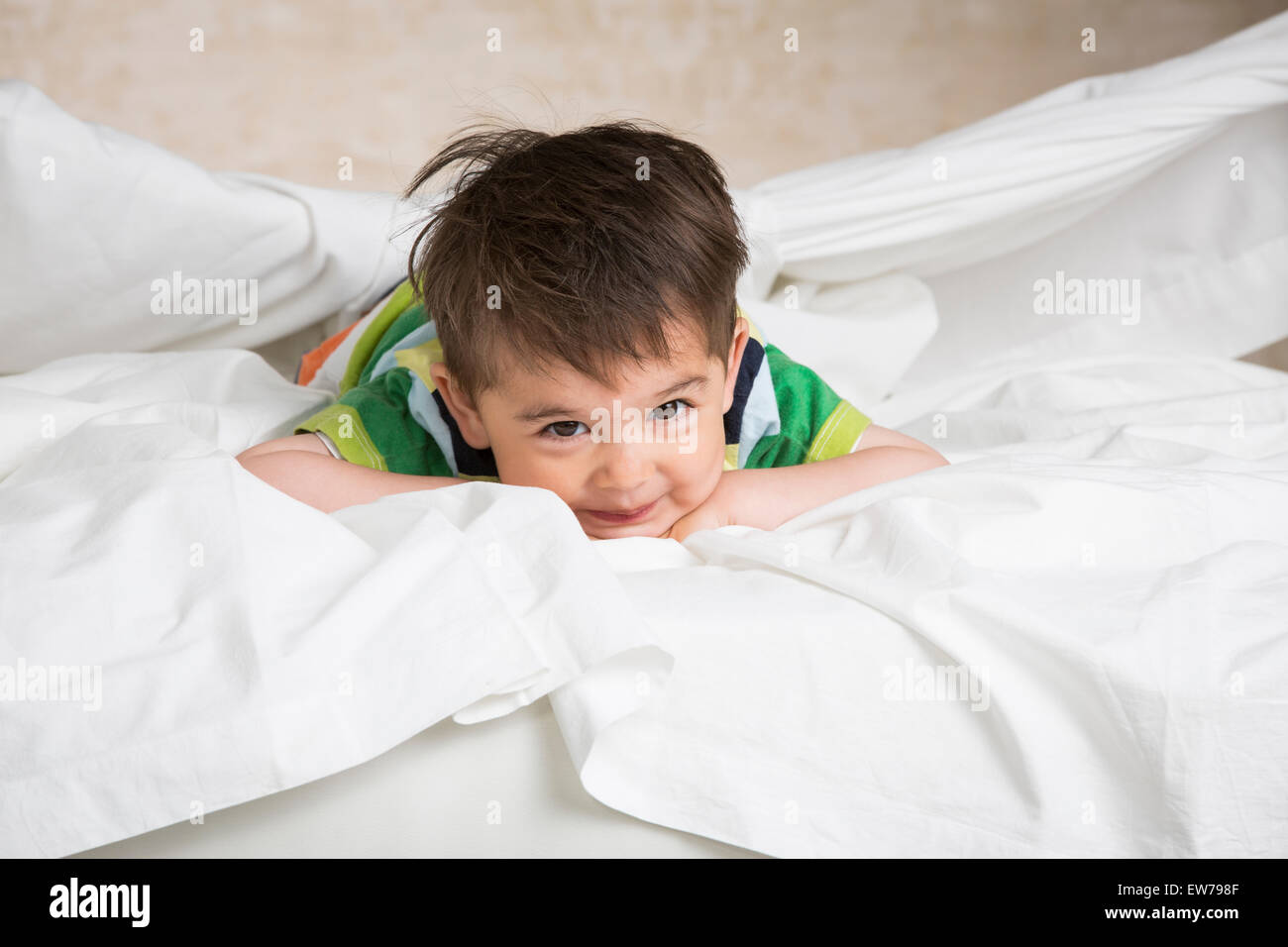 Little boy lying on a bed Stock Photo