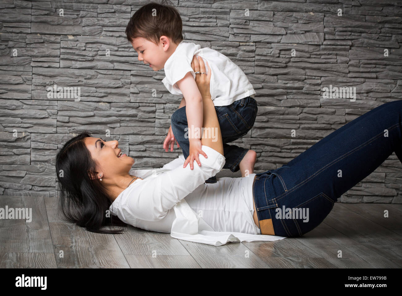 Mother and son playing on the floor Stock Photo