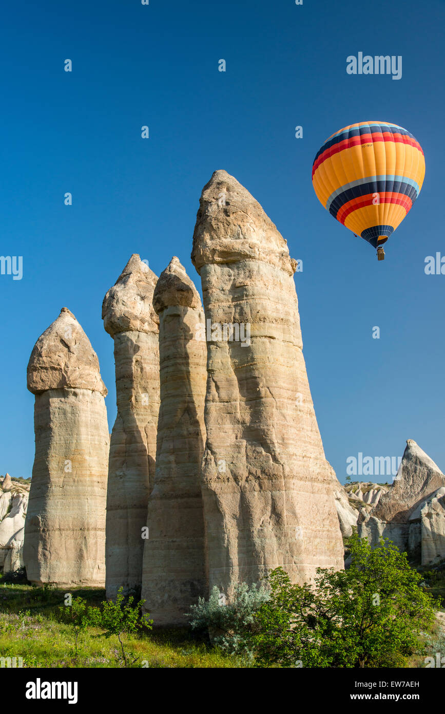 Scenic fairy chimneys landscape with hot air balloon, Goreme, Cappadocia, Turkey Stock Photo