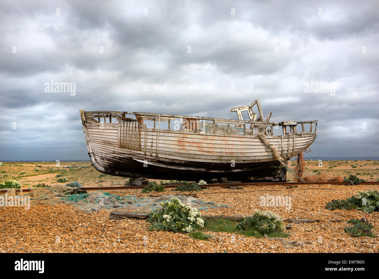 A derelict fishing boat on a shingle beach Stock Photo - Alamy
