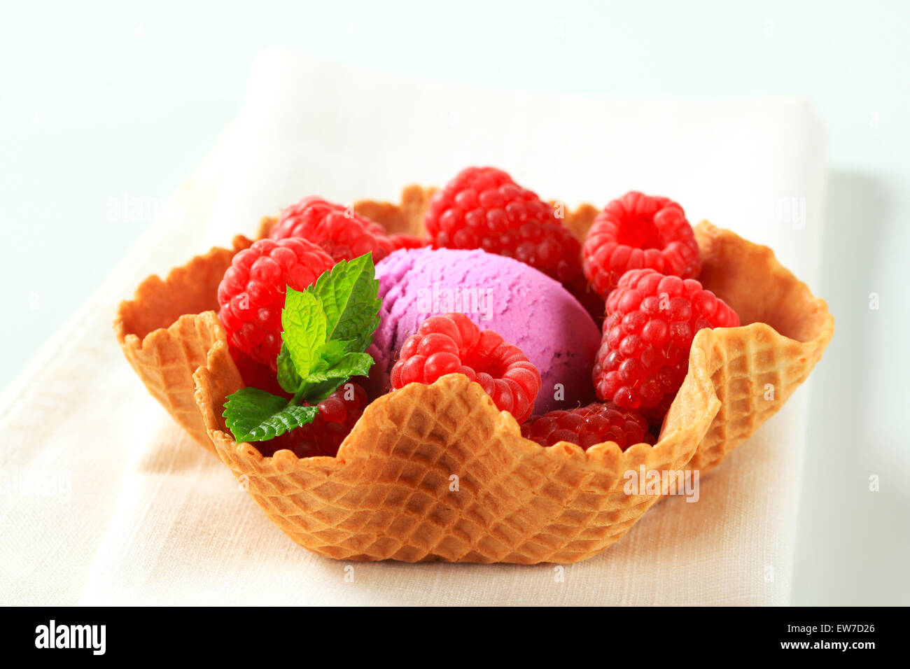 Scoop of fruit ice cream with fresh raspberries in a wafer bowl Stock