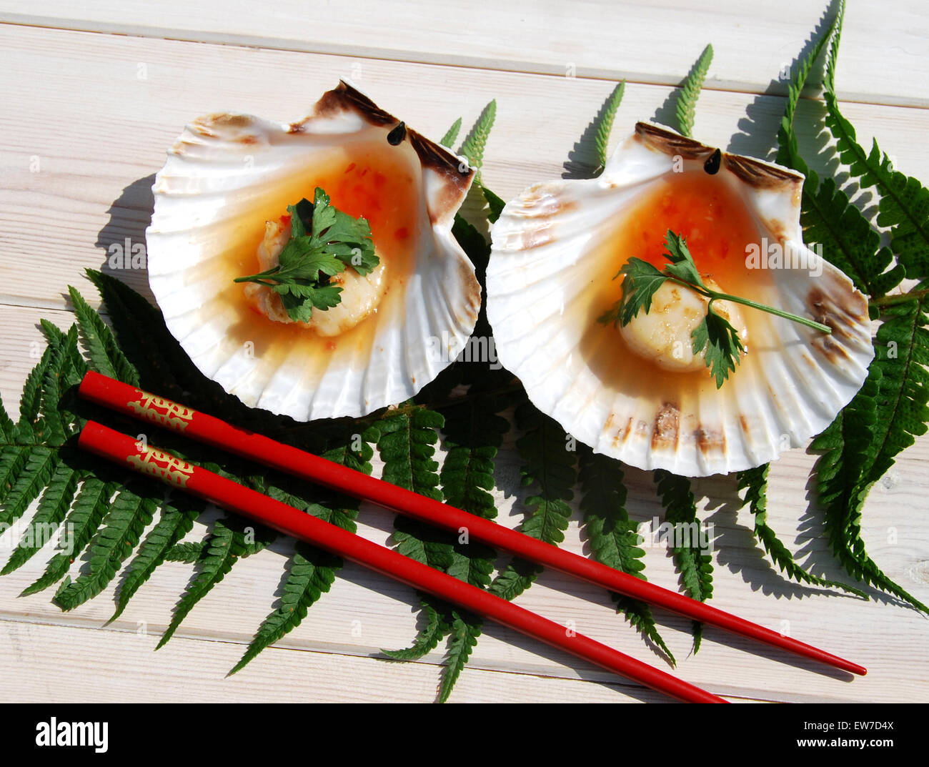 Barbecued Asian style Scallops displayed in shells with a lime and