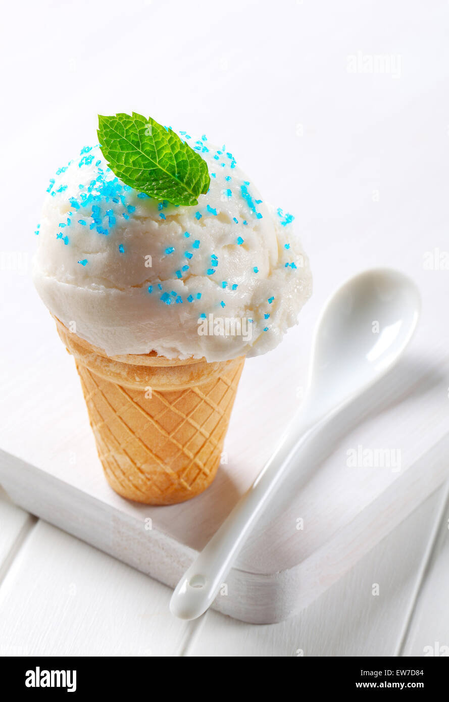 Lemon ice cream cone topped with sprinkles Stock Photo