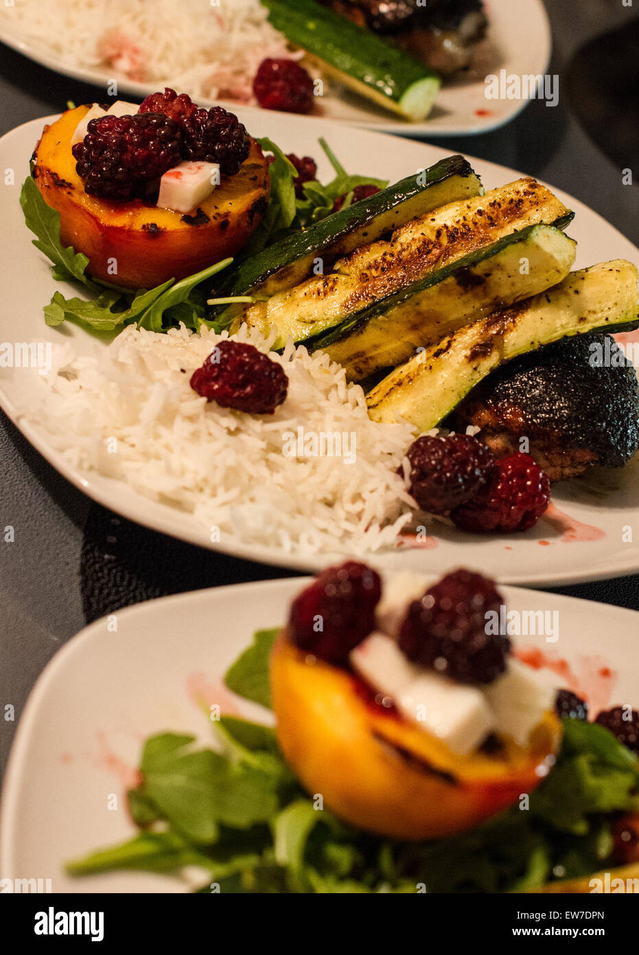 home made cooking and serving ready to eat rise vegetable meat and fruit served on a white plate. Stock Photo