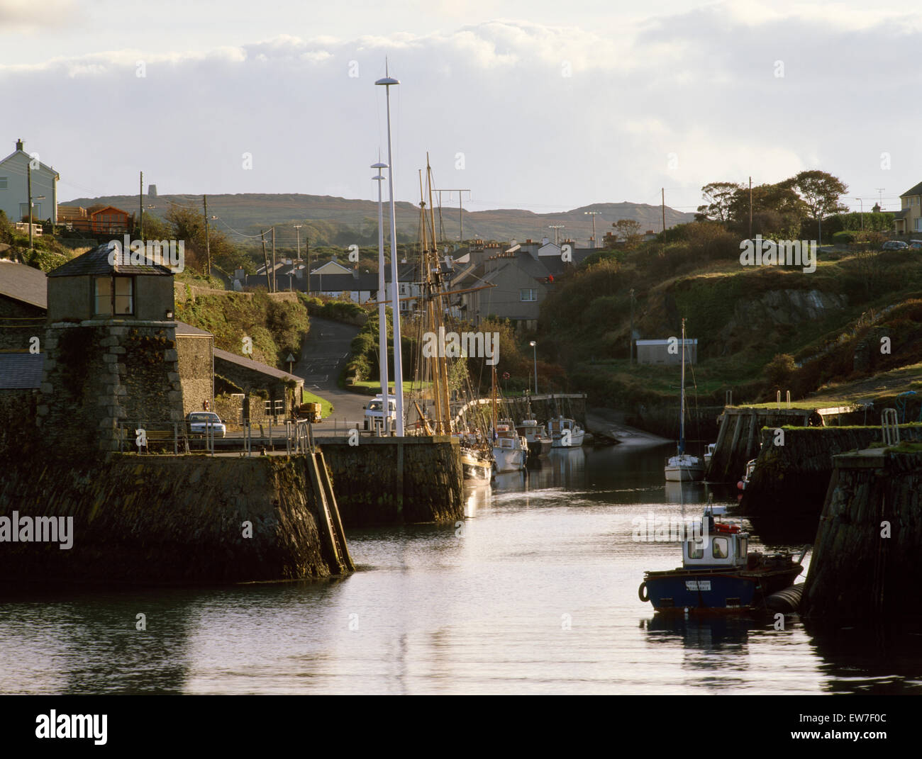 Amlwch Port, Anglesey enlarged & developed from late 1700s to process & export copper & other minerals from the Parys Mountain mines visible to rear. Stock Photo