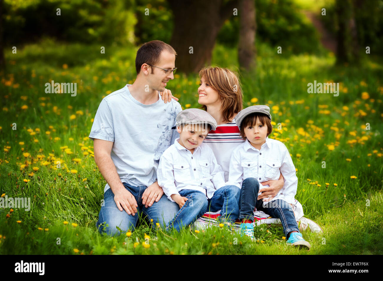 Family of four, mother, father and two boys, parent looking at each other, laughing, smiling, hugging, giving a kiss, holding fl Stock Photo - Alamy Family of four, mother, father and two boys, parent looking at each other, laughing, smiling, hugging, giving a kiss, holding fl Stock Photo - Alamy