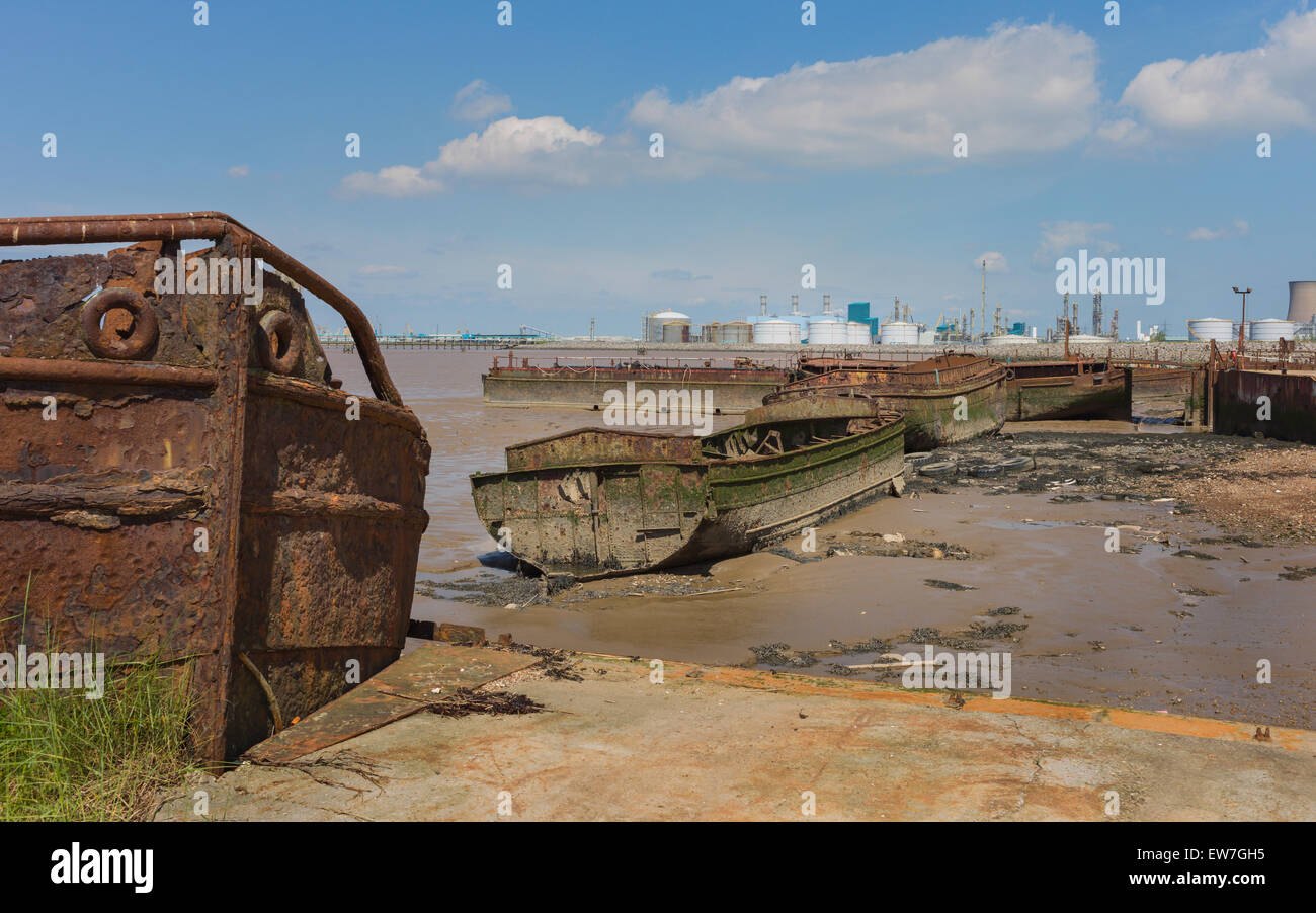 The mud banks of the Humber estuary at low tide flanking a disused ship yard, derelict ships, a chemical plant. Stock Photo