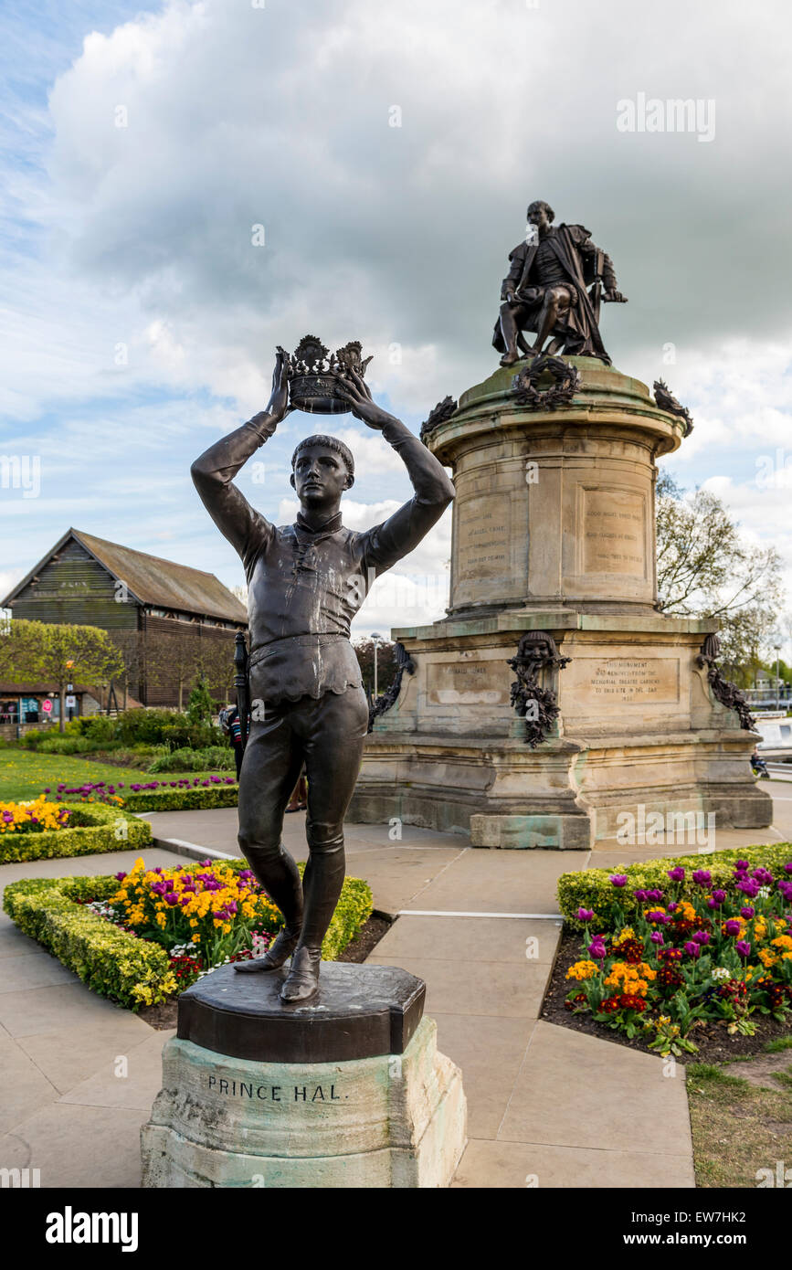 A statue of Shakespeare's Prince Henry, Hal or Henry V putting the crown on his head with a statue of Shakespeare behind. Stock Photo
