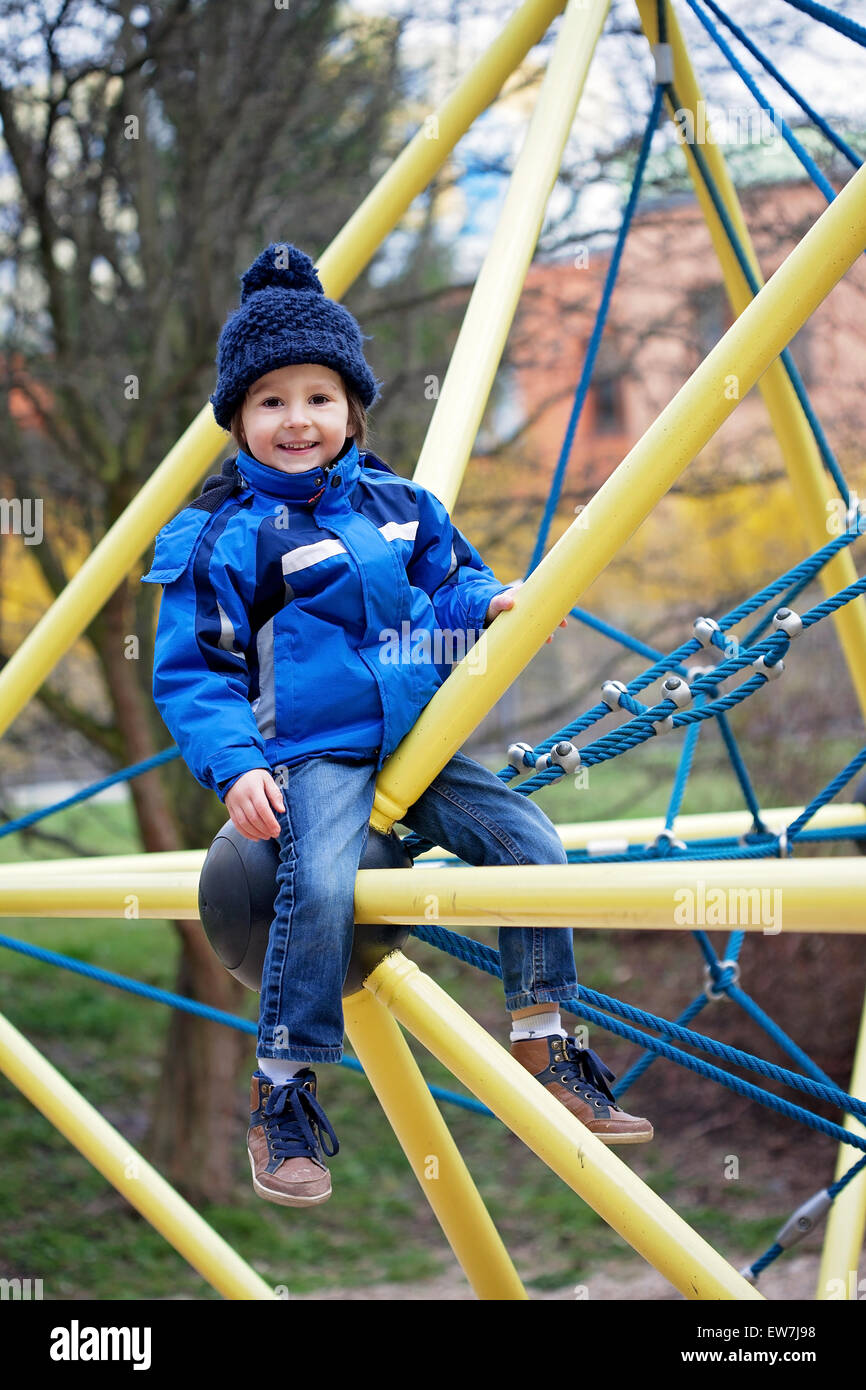 Cute boy, playing on the playground, springtime Stock Photo - Alamy