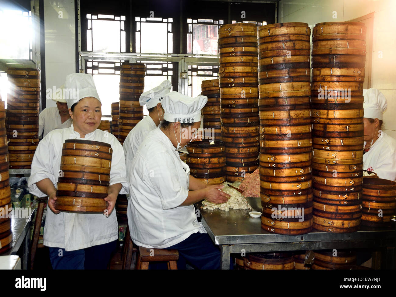 Yuyuan Garden Bazaar buildings founded by Ming dynasty Pan family ' Old Chinese city ' shopping area of Shanghai  China  ( Chinese chefs prepare Dim sum dumplings food baskets) Stock Photo