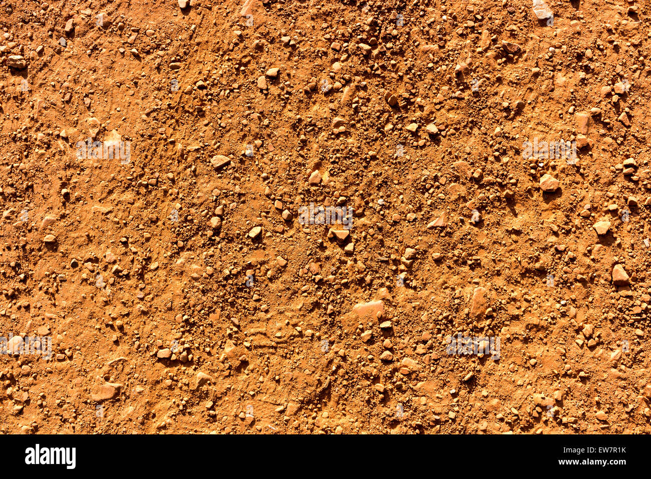 Red sand texture background with little stones in sports field Stock Photo