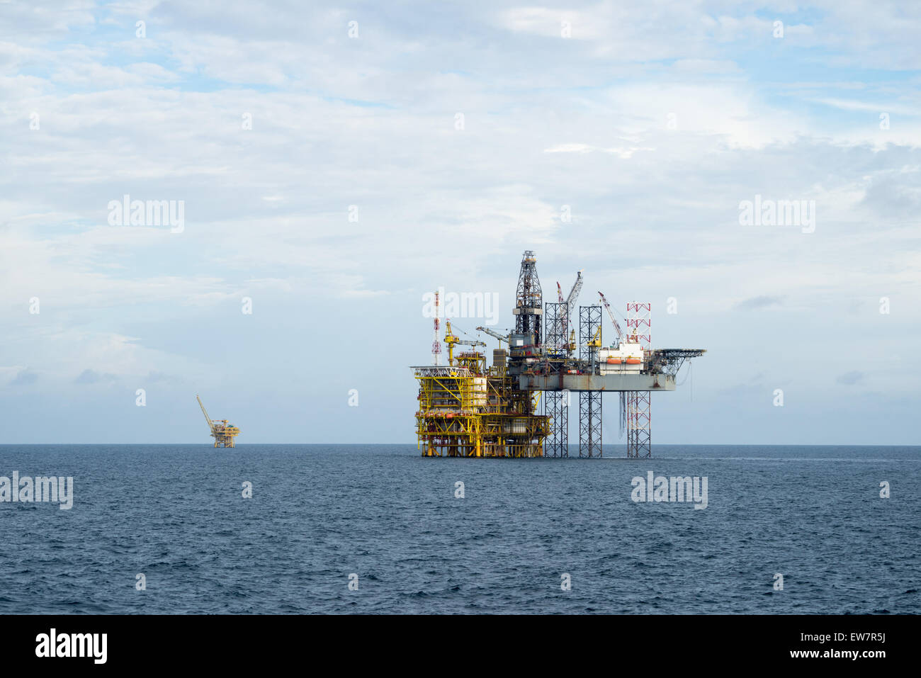 Drilling operation between Jack up and Oil processing platform at sea Stock Photo