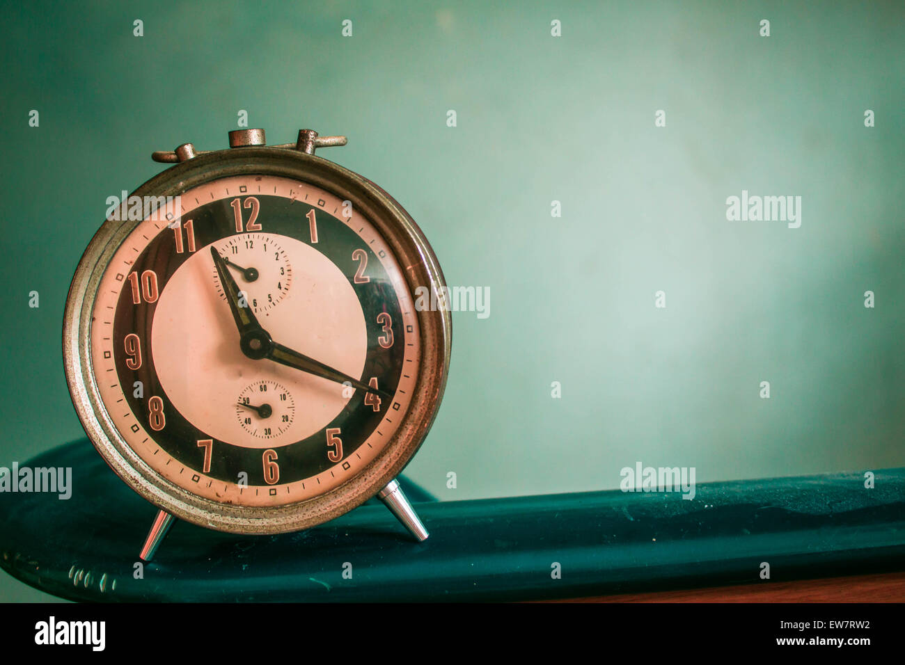 Old antique clock on the green background Stock Photo Alamy