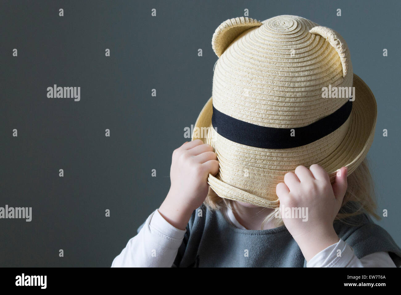 Girl pulling her hat down over her face Stock Photo Alamy