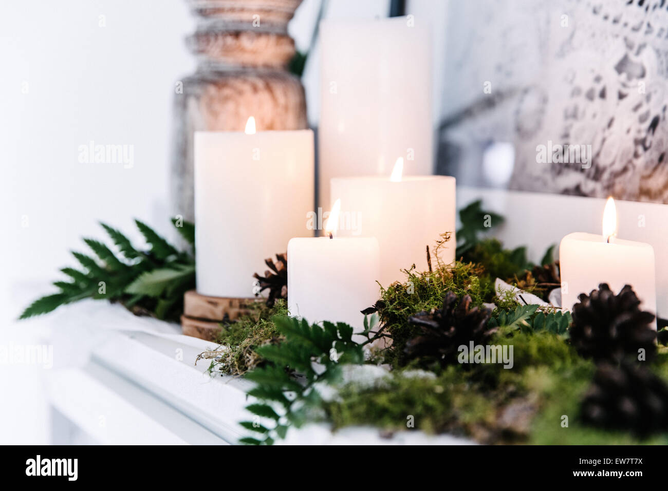 Candles on a mantelpiece with foliage decoration Stock Photo Alamy
