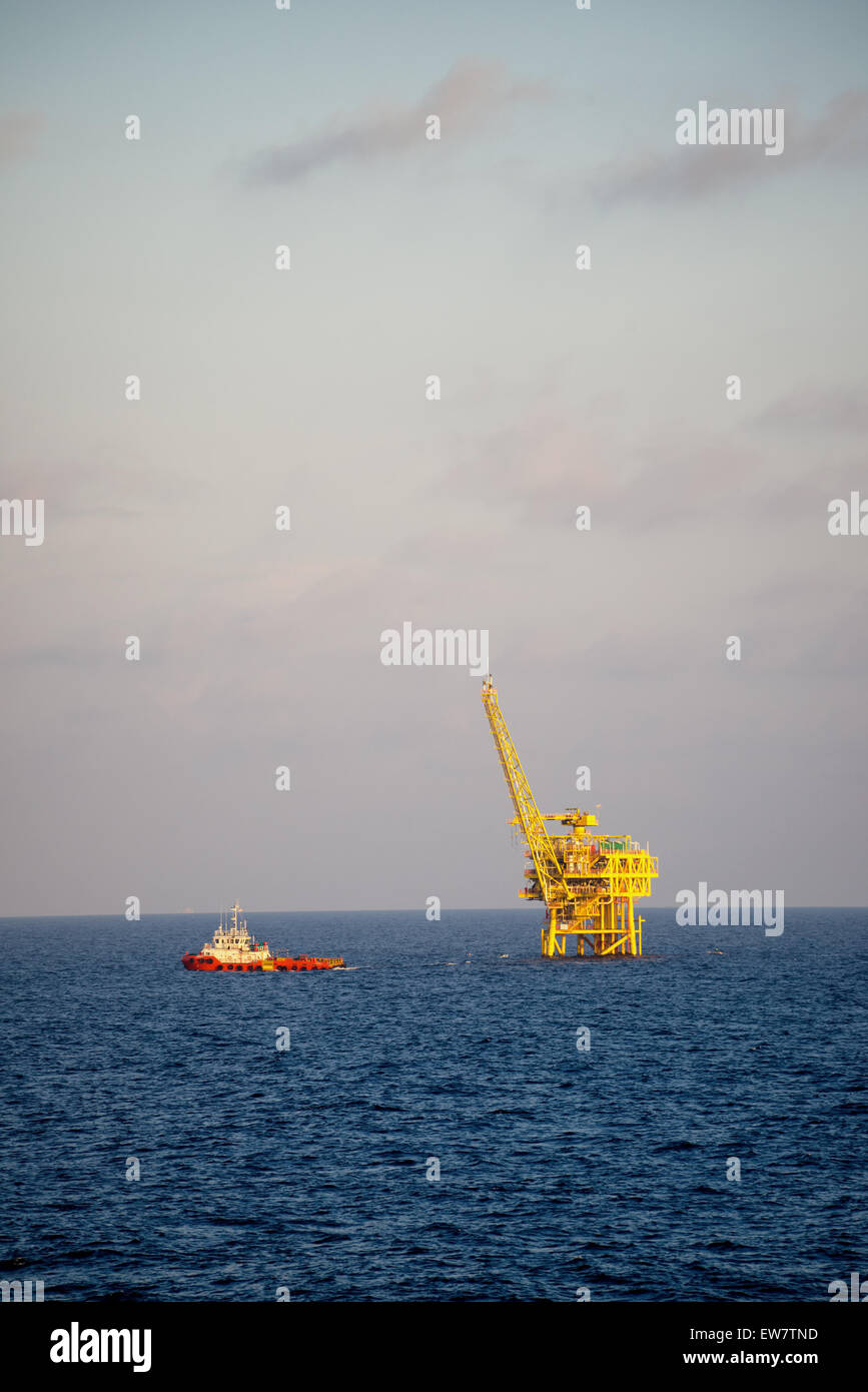 Supply ship leaving an oil and natural gas platform Stock Photo