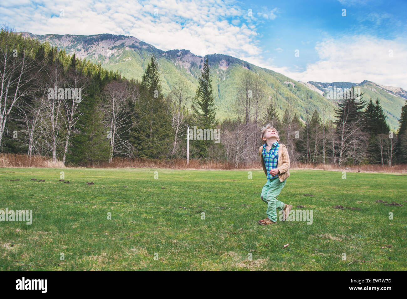 Boy spinning around in countryside Stock Photo