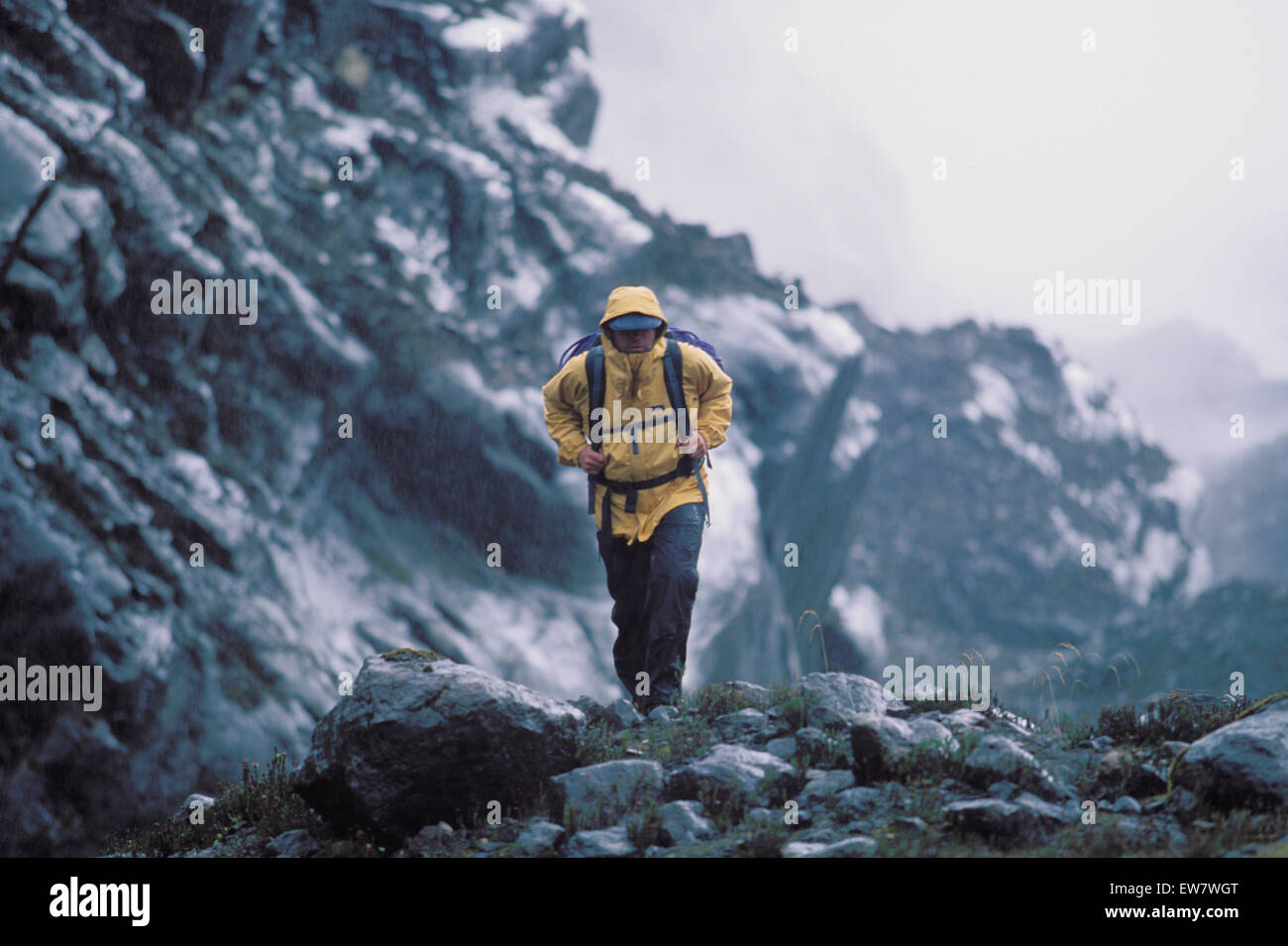 Man hiking up a snowy mountain Stock Photo Alamy