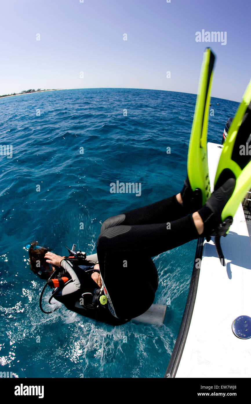 Diver enters water from side of boat, Turks and Caicos Islands Stock Photo