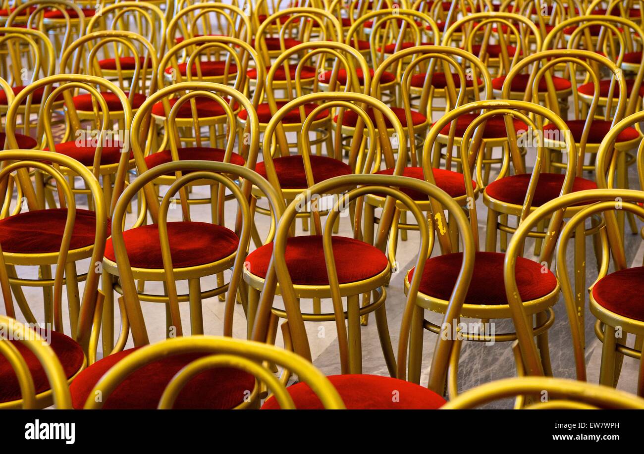 Rows of gold chairs with red cushions Stock Photo Alamy
