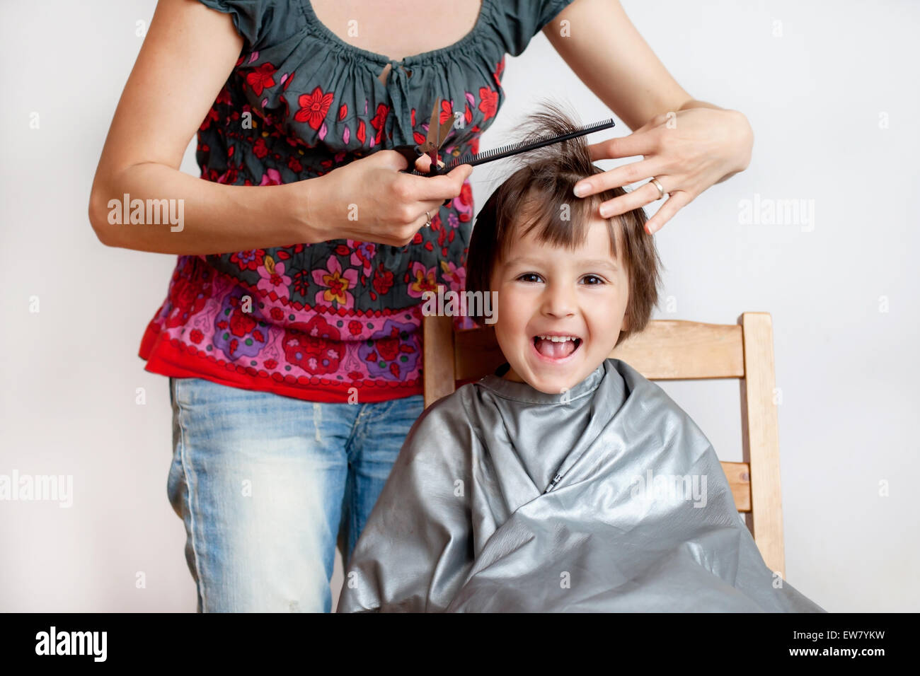 Cute Little Boy Having Haircut Smiling Happily White Background