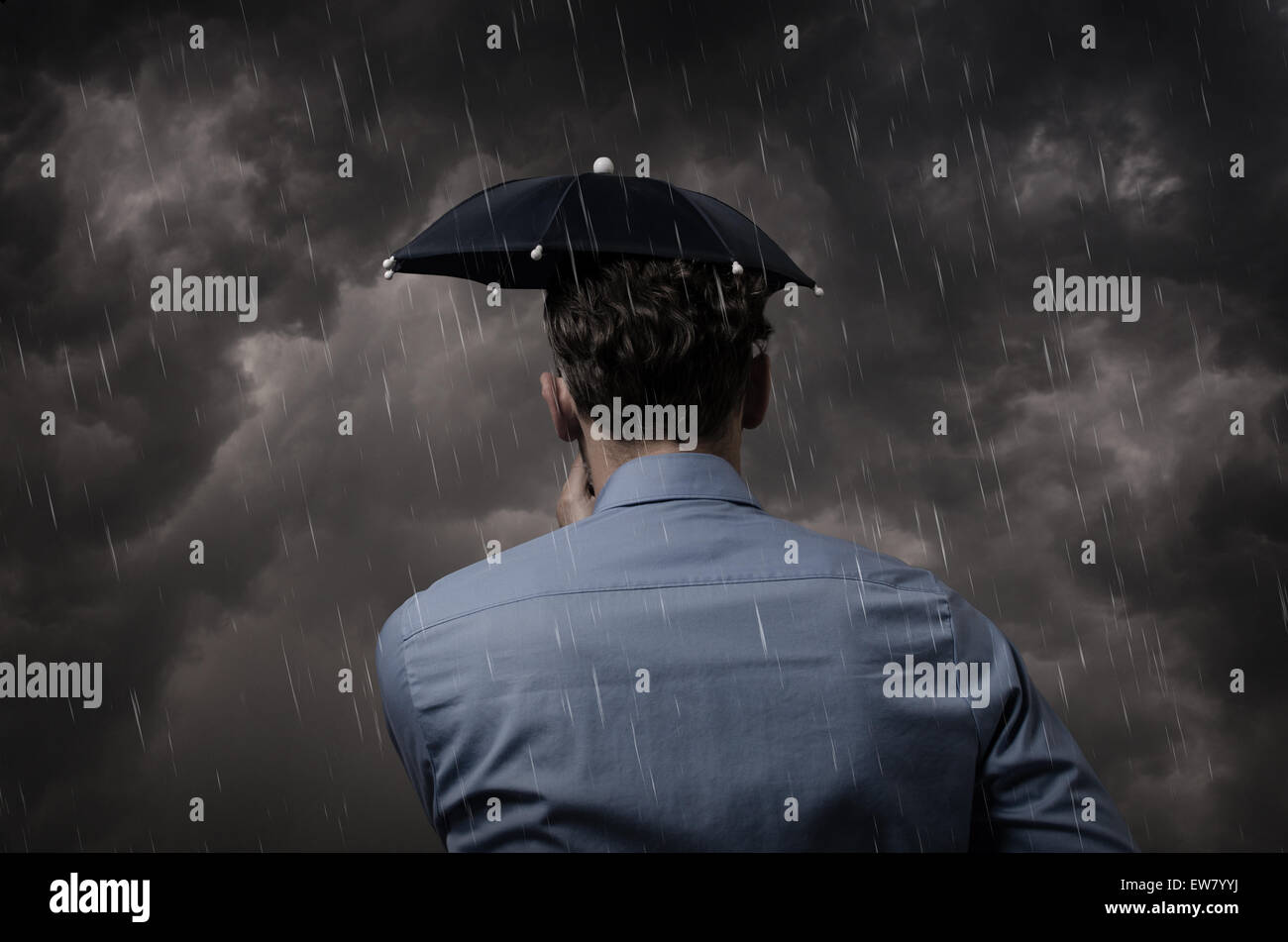 Business man with small umbrella in front of a heavy storm Stock Photo ...