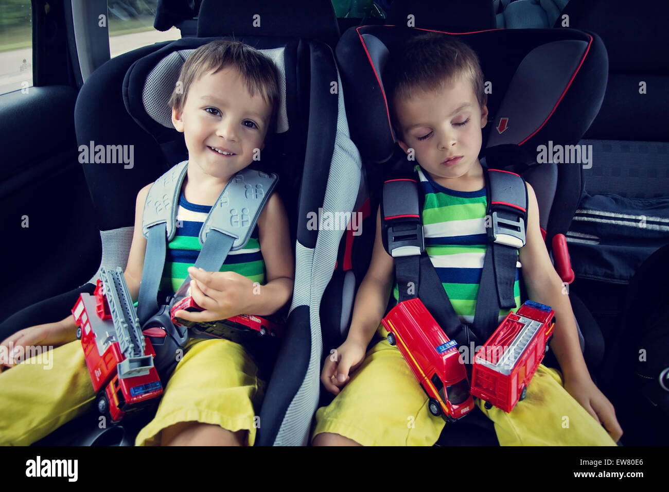 Two sweet boys, sleeping in the car with teddy bears after a long ... Two sweet boys, sleeping in the car with teddy bears after a long ...