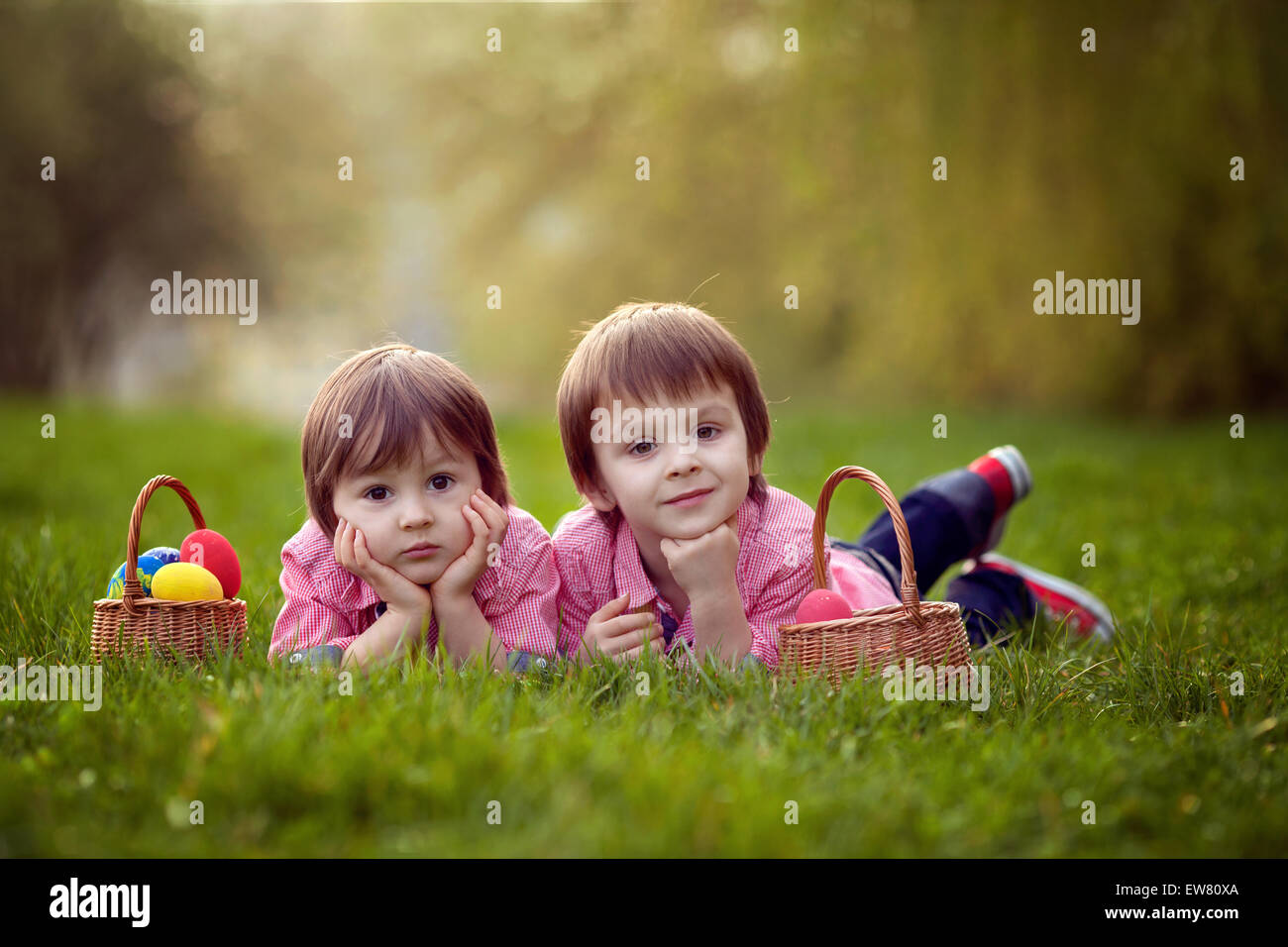 Two boys in the park, having fun with colored eggs for Easter Stock Photo
