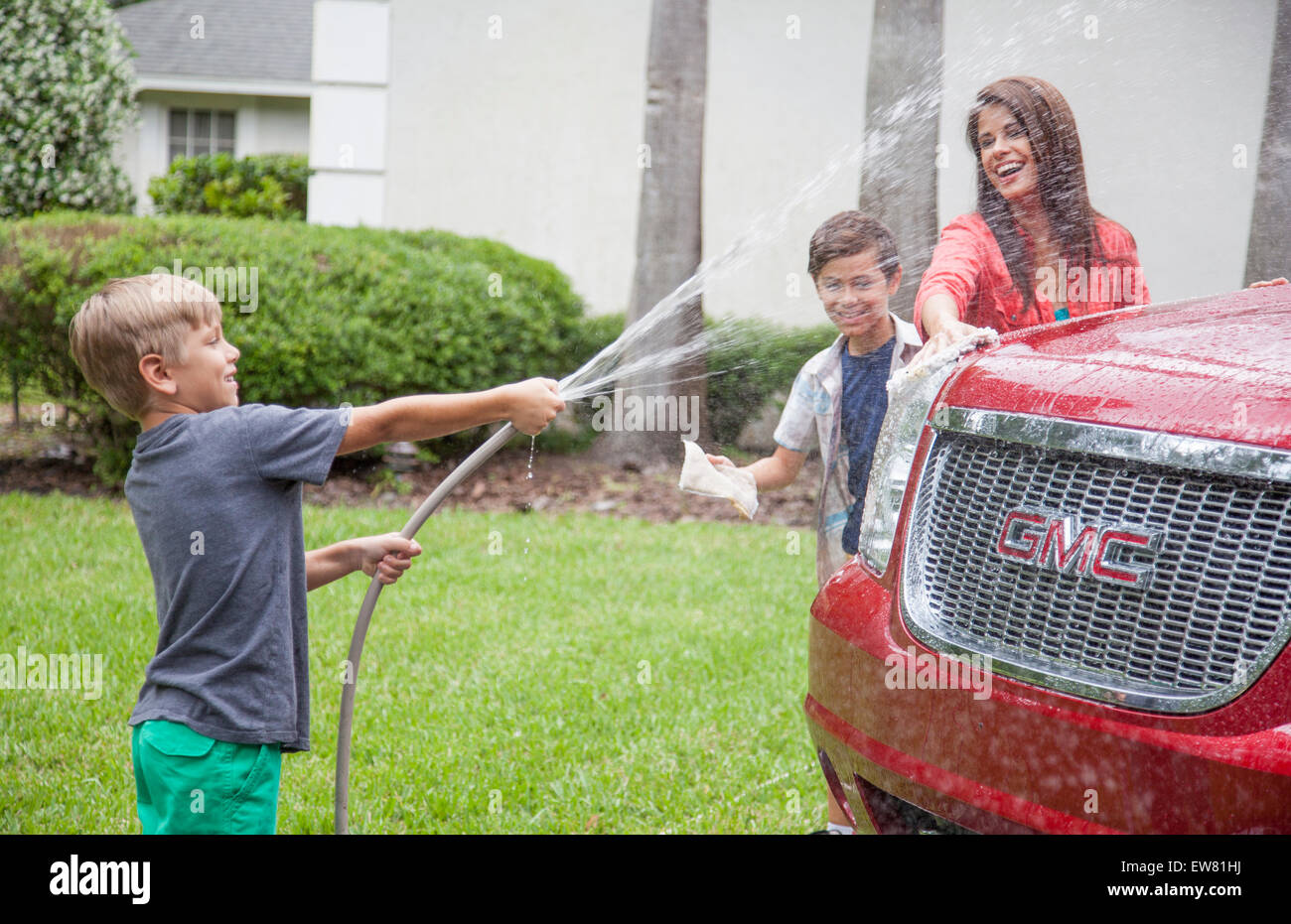 Family washing car together in driveway of home Stock Photo Alamy