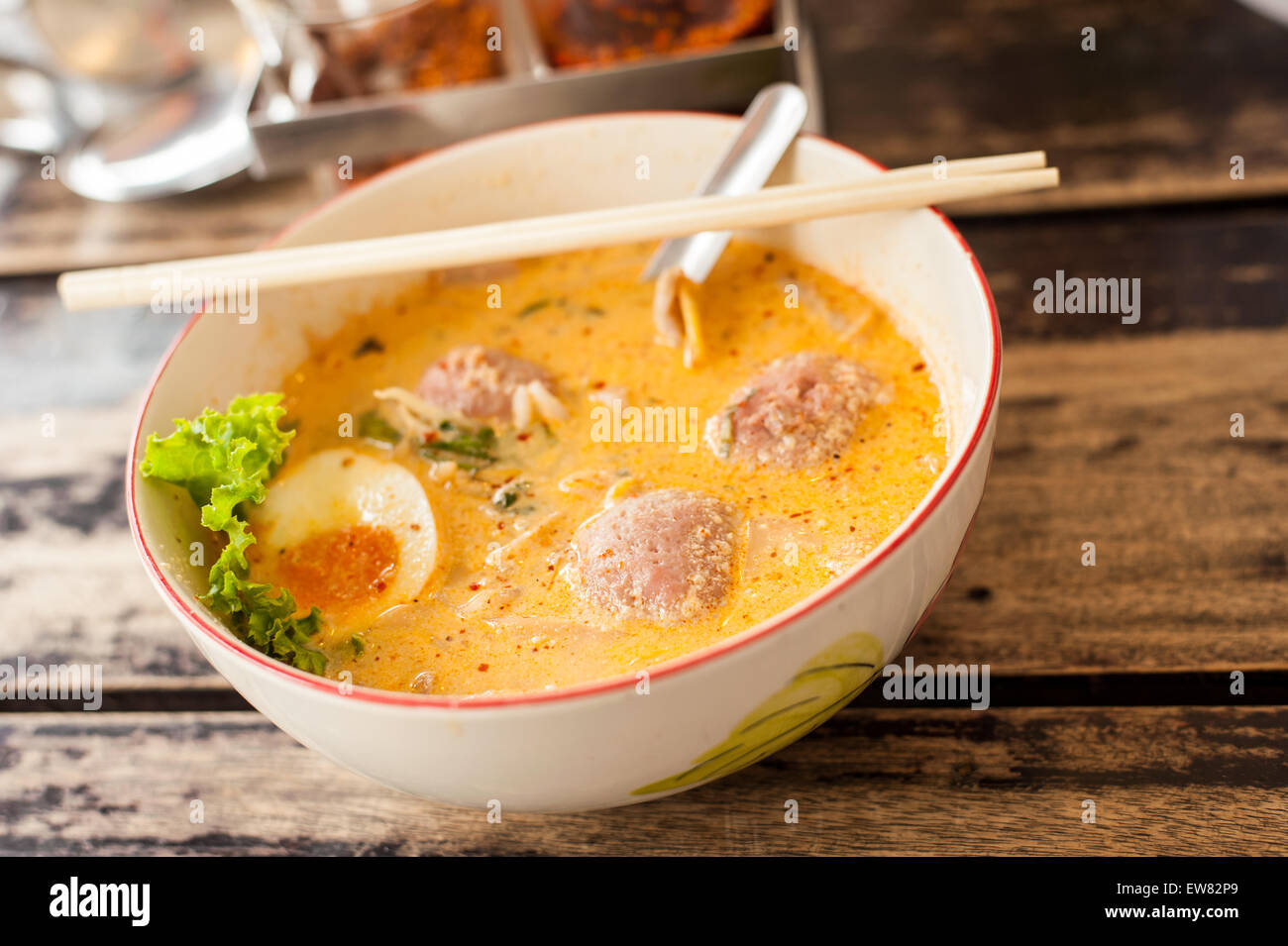 Thai food, Pork noodle tom yum, Water egg on wood table Stock Photo