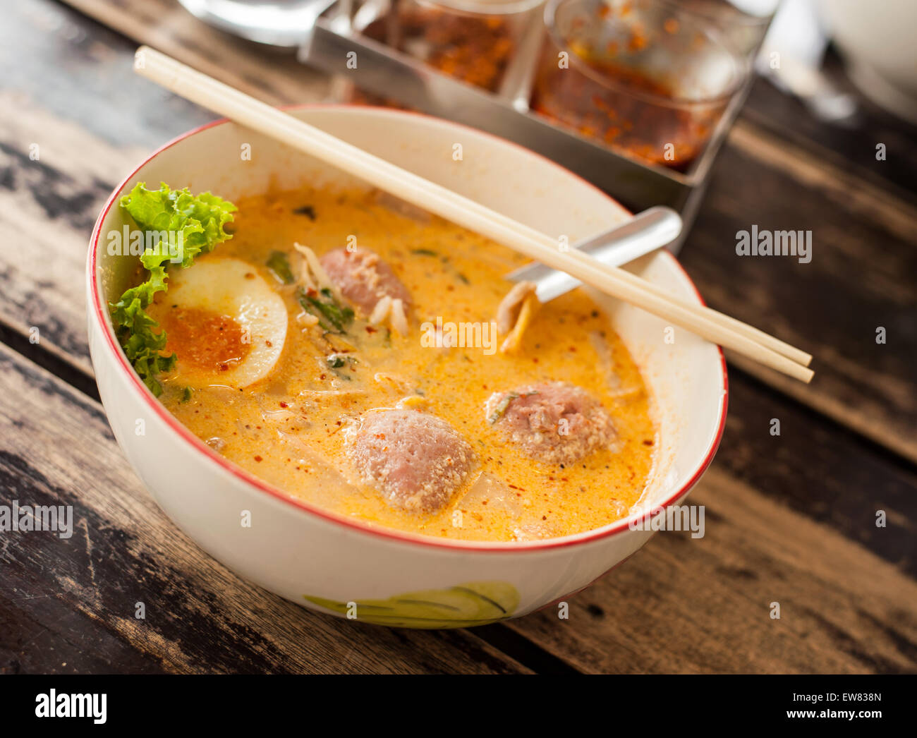 Thai food, Pork noodle tom yum, Water egg on wood table Stock Photo