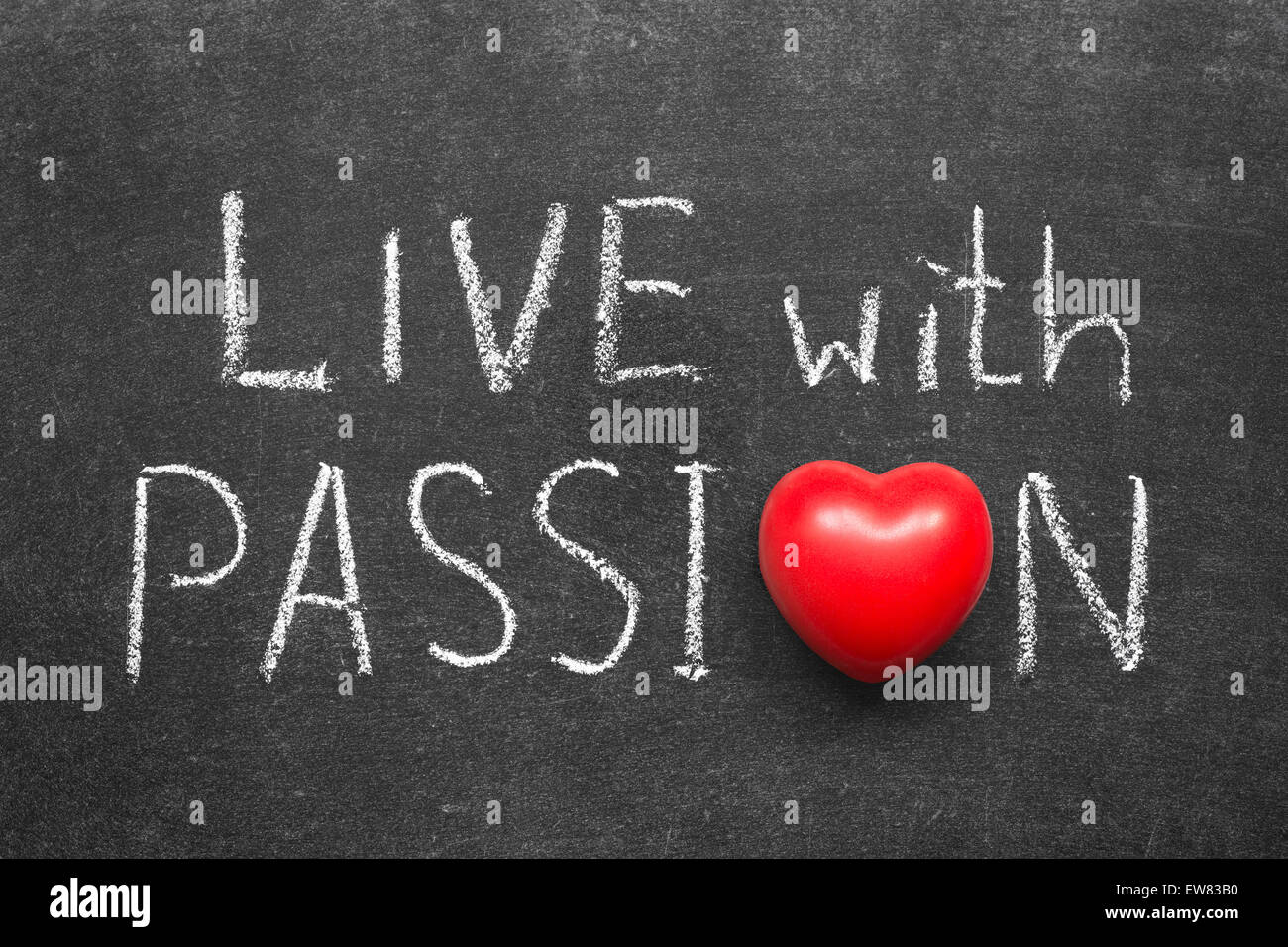 live with passion phrase handwritten on blackboard with heart symbol instead of O Stock Photo