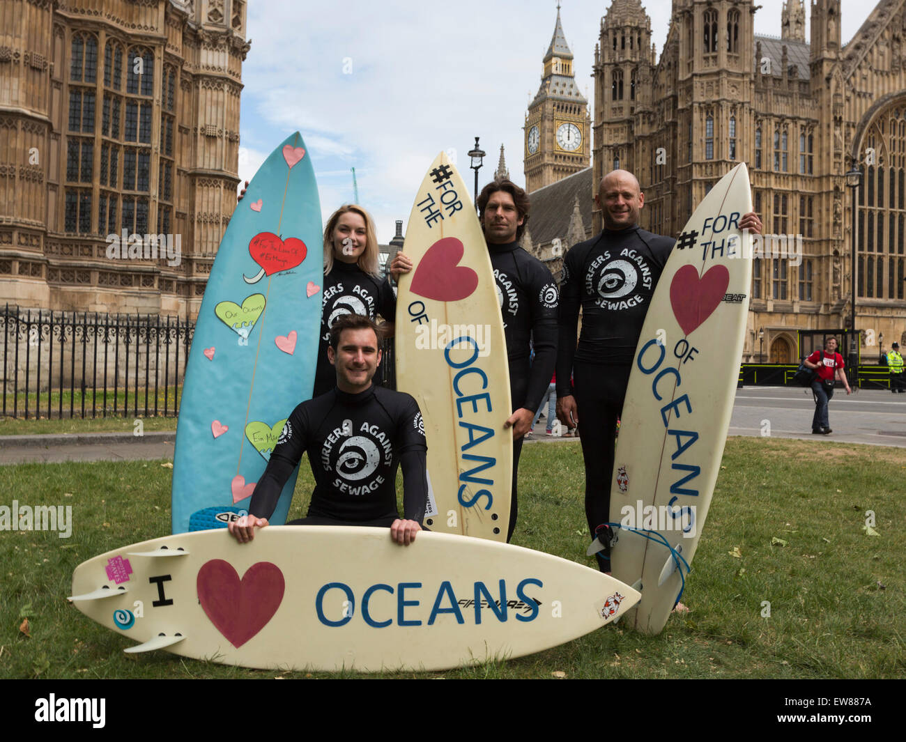 Climate Change activists with surfboards protest in Parliament Square before a large lobbying event with MPs on climate change at the Houses of Parliament. Stock Photo