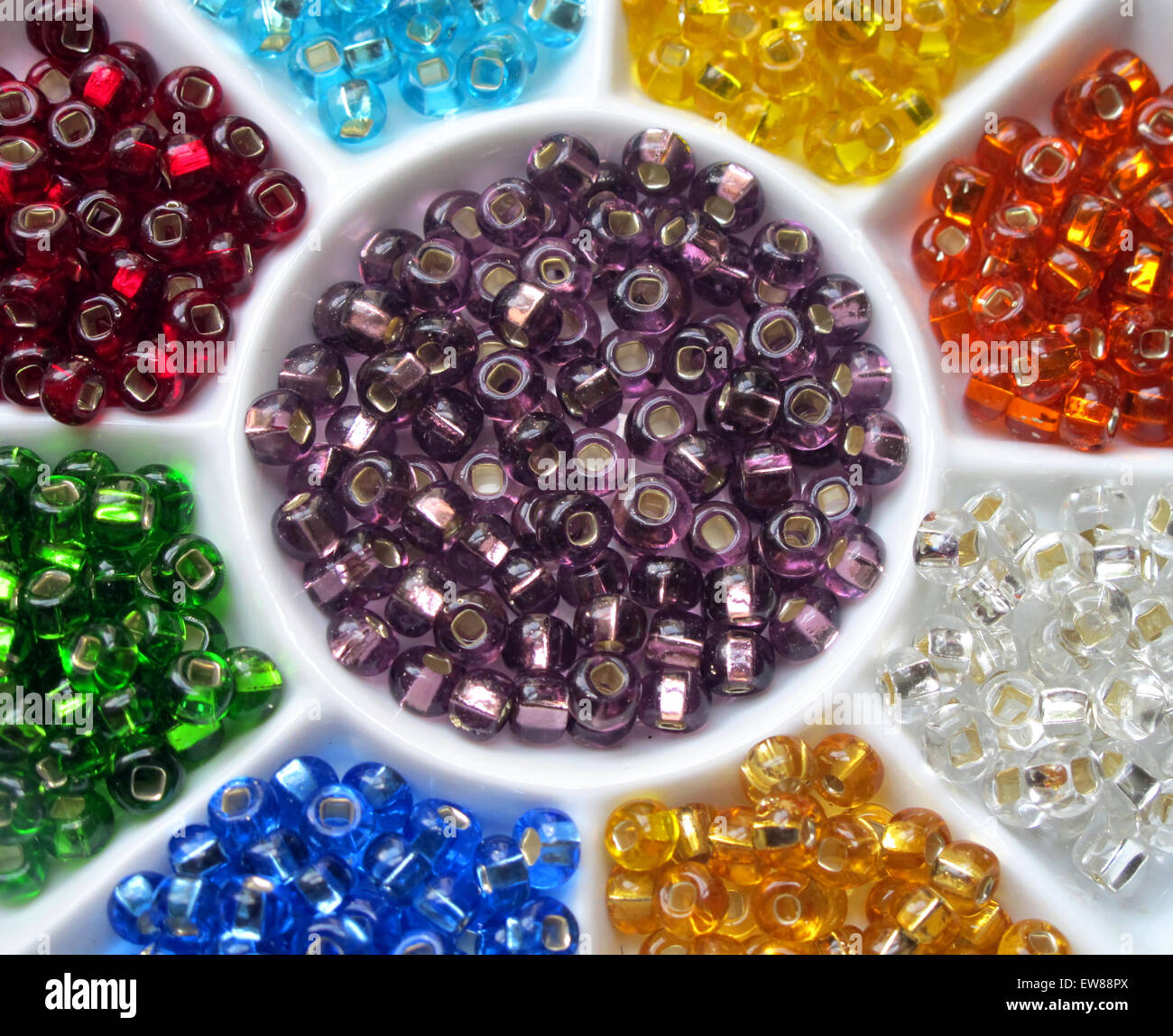 Colorful glass beads in a ceramic bead sorter. Stock Photo