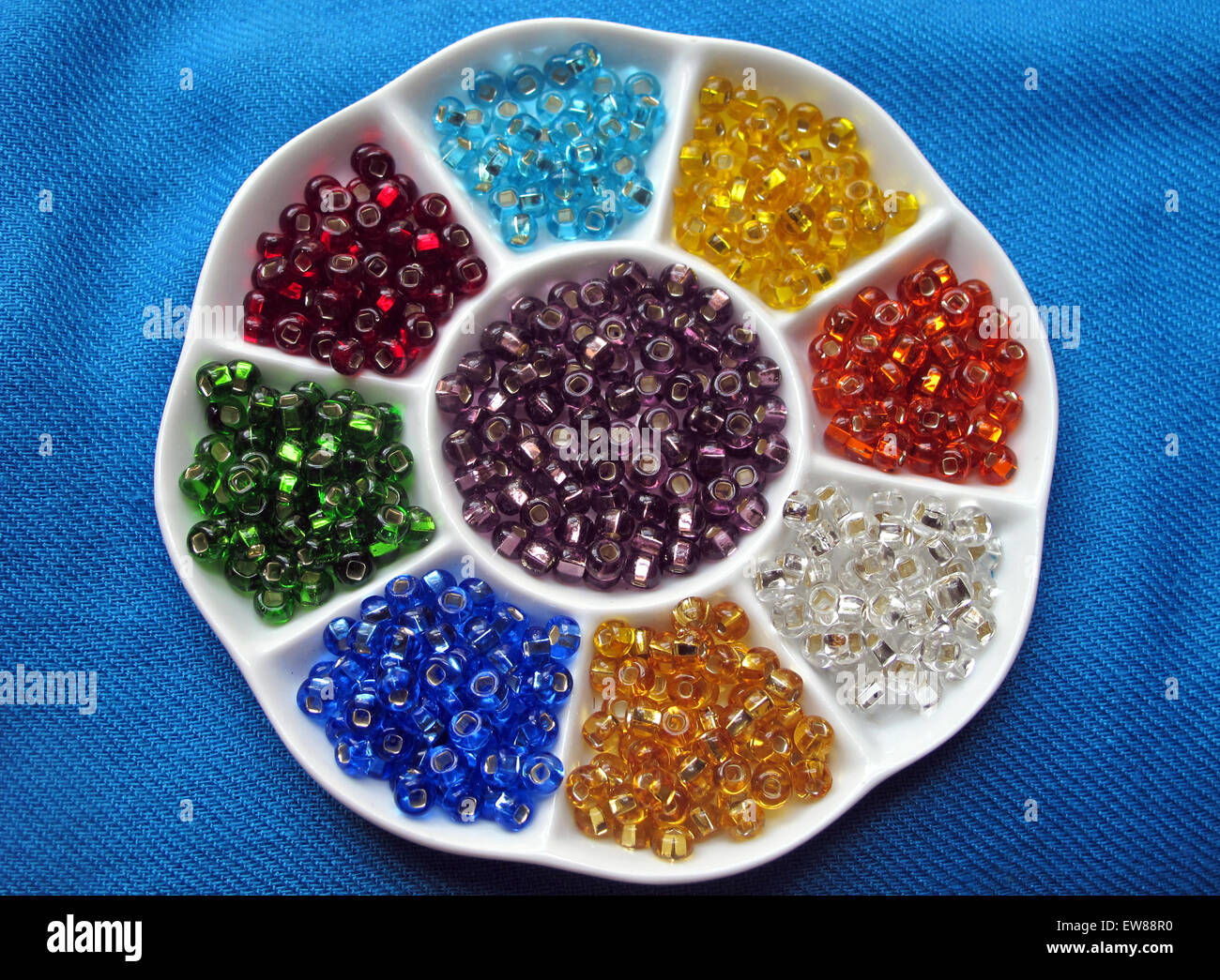 Colorful glass beads in a ceramic bead sorter. Stock Photo