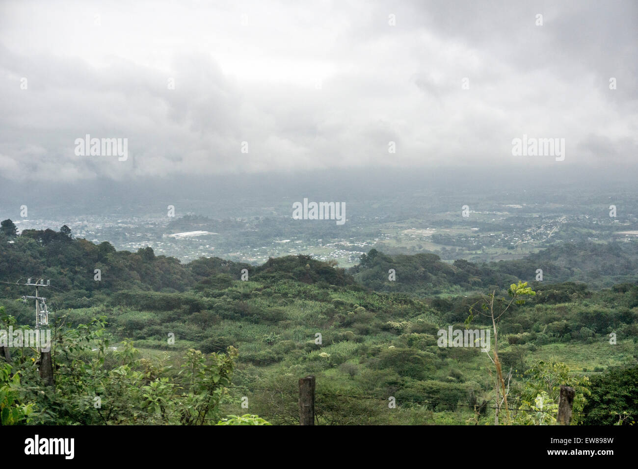 distant view of town of Ocosingo in the mist on a rainy day in Chiapas Stock Photo